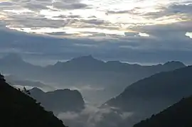 View of the rugged mountains of the Wa country with the valleys covered in mist.