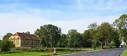 Road in Łukowo, with the manor visible