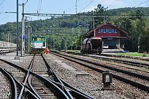 Two-story building with gabled roof next to railway yard