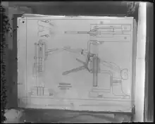 glass plate negative showing machine diagram pinned on wall