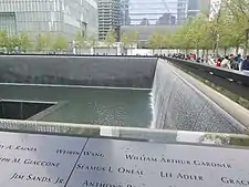 A black plaque with engravings of the names of people who died in the September 11 attacks