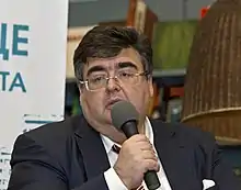 Aleksey Valentinovich Mitrofanov speaking into a microphone