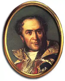 Portrait of a slightly balding man in blue uniform with gold collar