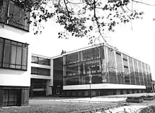 A grayscale image of a modern looking building.