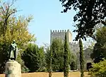 A monument in front of a castle