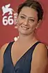 Giovanna Mezzogiorno at 2009 Venice Film Festival, wearing a dark blue dress and smiling