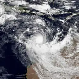 Satellite image of a powerful cyclone near the coast of Western Australia. The storm is relatively small but very mature, with a condensed area of deep thunderstorms and a well-defined, clear eye