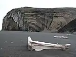 Egg-oeja, a peninsula on the coast of Jan Mayen. Sandy beach with a cliff in the background.