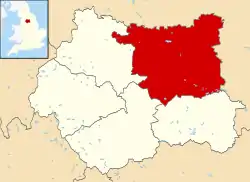 A map of England coloured pink showing the administrative subdivisions of the country. The Leeds metropolitan borough area is coloured red.