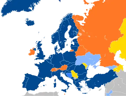 A map of Europe with countries in blue, cyan, orange, and yellow based on their NATO affiliation.