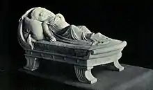 Monument of infant girl asleep on a couch