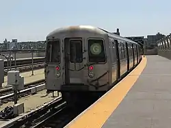 View of the end of a southbound "G" train at the elevated Smith-Ninth Streets station. The train consists of cars with the contract name R68.