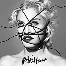 Black-and-white image of Madonna's face, with black strings going criss-cross over it