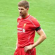 A man wearing a red football kit.