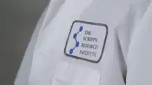 A lab coat with a The Scripps Research Institute patch