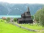 Urnes Church, a wooden building with a cemetery in front.