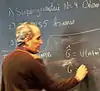  Edward Witten writing on a blackboard