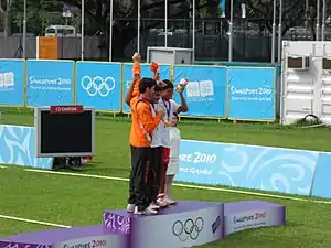 Medallists of the Junior Men's Individual archery competition at the 2010 Summer Youth Olympics on the victory podium at Kallang Field, Singapore