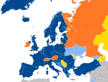 A map of Europe with countries in blue, cyan, orange, and yellow based on their NATO affiliation.