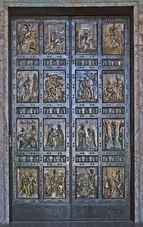  A pair of bronze doors divided into sixteen panels containing reliefs depicting scenes mainly from the life of Jesus and stories that he told.