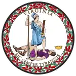 A circular seal with the words "Virginia" on the top and "Sic Semper Tyrannis" on the bottom. In the center, a woman wearing a blue toga and Athenian helmet stands on the chest of dead man wearing a purple breastplate and skirt. The woman holds a spear and sheathed sword. The man holds a broken chain while his crown lies away from the figures. Orange leaves encircle the seal.