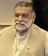 A beard man sitting in an office.